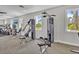 Fully-equipped fitness center with weight machines and scenic windows offers a complete workout experience at 5715 Woodland Sage Dr, Sarasota, FL 34238