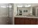 Well-lit bathroom featuring double sinks, granite countertops, and a glass-enclosed shower at 5720 Palmer Cir # 103, Bradenton, FL 34211