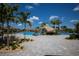 Resort-style community pool area with palm trees, waterfalls, and plenty of space to relax at 5720 Palmer Cir # 103, Bradenton, FL 34211