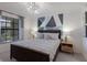 Comfortable main bedroom with a stylish accent wall, modern lighting, and neutral-toned bedding at 5720 Palmer Cir # 103, Bradenton, FL 34211
