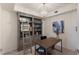 Stylish home office with custom built-ins, a modern desk, and decorative lighting at 5720 Palmer Cir # 103, Bradenton, FL 34211