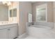 Bathroom with soaking tub, marble tile and shuttered window at 5749 Sunflower Cir, Sarasota, FL 34238