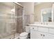 Bathroom featuring tiled walk-in shower, double vanity, and modern fixtures at 5749 Sunflower Cir, Sarasota, FL 34238