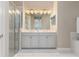 Bathroom with walk-in shower, double sinks, and marble counter at 5749 Sunflower Cir, Sarasota, FL 34238