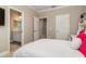 Well-lit bedroom with white bed and an ensuite bathroom at 5749 Sunflower Cir, Sarasota, FL 34238