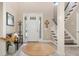 Inviting foyer with a high ceiling, stylish staircase, and a decorative round area rug at 5749 Sunflower Cir, Sarasota, FL 34238