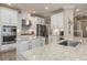 Bright kitchen with stainless steel appliances, white cabinets, and granite countertops at 5749 Sunflower Cir, Sarasota, FL 34238