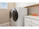 Bright laundry area featuring a modern washer and dryer, with convenient counter space and plenty of cabinet storage at 5749 Sunflower Cir, Sarasota, FL 34238