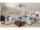 Open-concept living room with a comfortable sectional sofa and views into the kitchen and dining area at 5749 Sunflower Cir, Sarasota, FL 34238