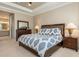 Main bedroom with large bed, and shuttered windows at 5749 Sunflower Cir, Sarasota, FL 34238