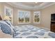 Bedroom featuring shuttered windows and a tray ceiling at 5749 Sunflower Cir, Sarasota, FL 34238