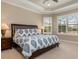 Main bedroom with tray ceilings and shuttered windows at 5749 Sunflower Cir, Sarasota, FL 34238