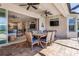 Covered patio featuring an entertainment area with a ceiling fan and a view of the living spaces through an open slider at 5749 Sunflower Cir, Sarasota, FL 34238