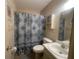 Bathroom featuring a vanity, toilet, and a shower with patterned curtain at 6072 Arlene Way # 6072, Bradenton, FL 34207
