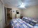 Bedroom featuring two twin beds with matching floral bedding and ceiling fan at 6072 Arlene Way # 6072, Bradenton, FL 34207