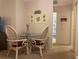 Cozy dining area with glass-top table and wicker chairs at 6072 Arlene Way # 6072, Bradenton, FL 34207