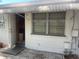 Exterior view featuring white walls, a window, and an open doorway at 6072 Arlene Way # 6072, Bradenton, FL 34207