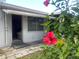 Exterior showing the white wall with a window and a hibiscus plant at 6072 Arlene Way # 6072, Bradenton, FL 34207