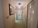 Hallway leading to front door with closet doors and a picture on the wall at 6072 Arlene Way # 6072, Bradenton, FL 34207