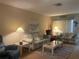 Cozy living room with neutral tones and comfortable striped sofas at 6072 Arlene Way # 6072, Bradenton, FL 34207