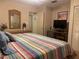 Comfortable main bedroom with striped bedding and ample closet space at 6072 Arlene Way # 6072, Bradenton, FL 34207