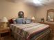 Comfortable main bedroom with striped bedding and ample closet space at 6072 Arlene Way # 6072, Bradenton, FL 34207