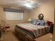 Main bedroom featuring striped bedding, ceiling fan, and a window at 6072 Arlene Way # 6072, Bradenton, FL 34207