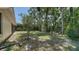 View of the expansive backyard with mature trees and lush landscaping at 6128 Nicole Dr, Sarasota, FL 34243