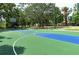 Outdoor basketball court with vibrant green and blue playing surface at 6128 Nicole Dr, Sarasota, FL 34243