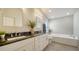 Bathroom features dual sinks, granite counters, tub, and wood-look floors at 6128 Nicole Dr, Sarasota, FL 34243