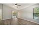 Bright bedroom featuring wood-look flooring, sliding glass doors, and ceiling fan at 6128 Nicole Dr, Sarasota, FL 34243