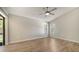 Large bedroom offers ample space with neutral walls, wood-look floors, and private access to the porch at 6128 Nicole Dr, Sarasota, FL 34243