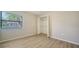 Bedroom features wood-look floors, closet and natural light at 6128 Nicole Dr, Sarasota, FL 34243