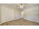 Bedroom with ceiling fan, wood-look floors, and closet at 6128 Nicole Dr, Sarasota, FL 34243
