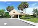 Community center exterior with well-maintained landscaping and palm trees at 6128 Nicole Dr, Sarasota, FL 34243