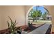 Beautiful arched entryway showcasing lush landscaping and a glimpse of the inviting neighborhood beyond at 6128 Nicole Dr, Sarasota, FL 34243