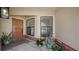 Welcoming front porch with neutral tones, potted plants, and a secure front door for a cozy entrance at 6128 Nicole Dr, Sarasota, FL 34243
