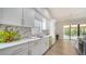 Bright kitchen featuring white cabinetry, marble backsplash, and a spacious layout perfect for cooking and entertaining at 6128 Nicole Dr, Sarasota, FL 34243