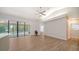 Spacious living room featuring vaulted ceiling, neutral colors, wood-look floors and access to the screened porch at 6128 Nicole Dr, Sarasota, FL 34243