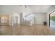 Bright living room featuring vaulted ceiling, neutral colors, wood-look floors and access to the screened porch at 6128 Nicole Dr, Sarasota, FL 34243
