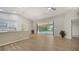 Bright living room with hardwood floors, modern lighting, and a seamless transition to outdoor living space at 6128 Nicole Dr, Sarasota, FL 34243