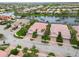 Aerial view of a neighborhood with a lake and mature landscaping, with beautiful waterfront views at 6209 Erice St, Venice, FL 34293