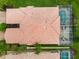 Aerial view of house with red tile roof and screened in pool overlooking the lush green landscaping at 6209 Erice St, Venice, FL 34293