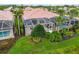 Aerial shot of screened-in pool with view of lush backyard landscaping and canal at 6209 Erice St, Venice, FL 34293
