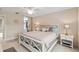 Well lit bedroom featuring a ceiling fan, a view into the en suite, and walk in closet at 6209 Erice St, Venice, FL 34293