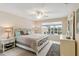 A clean bedroom has great natural light, a ceiling fan and neutral wall color at 6209 Erice St, Venice, FL 34293