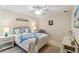 Bright bedroom featuring light walls, and a ceiling fan, with a turtle themed bed at 6209 Erice St, Venice, FL 34293