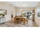 Relaxing dining room with backyard views, neutral paint, wood floors and an updated chandelier for seamless enjoyment at 6209 Erice St, Venice, FL 34293