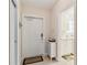 Home interior showcasing the front door entryway, tile floors, and a glimpse of the laundry room at 6209 Erice St, Venice, FL 34293