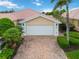 Exterior shot of a home featuring a well maintained brick driveway and an attached two car garage with carriage doors at 6209 Erice St, Venice, FL 34293